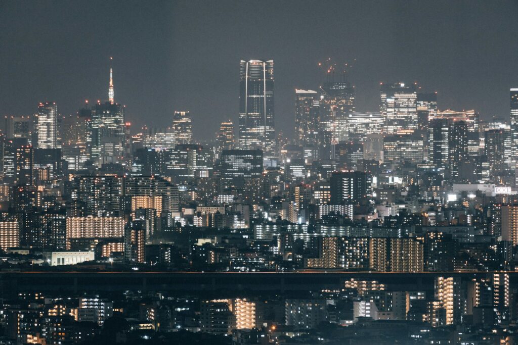 A view of a city at night from the top of a hill