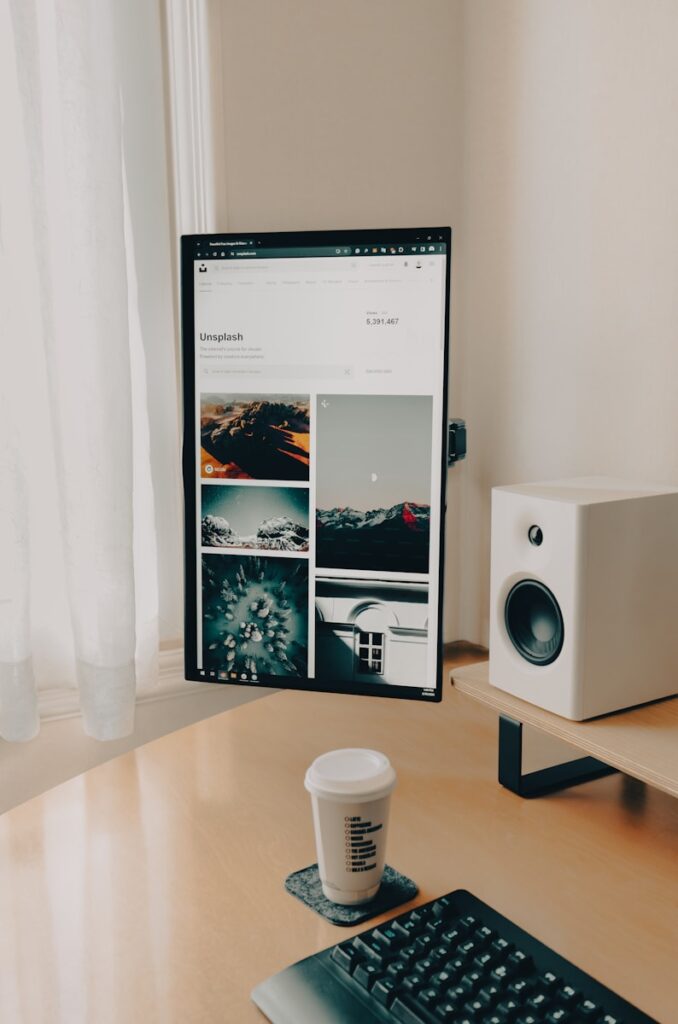 a coffee cup sitting on a desk next to a computer monitor